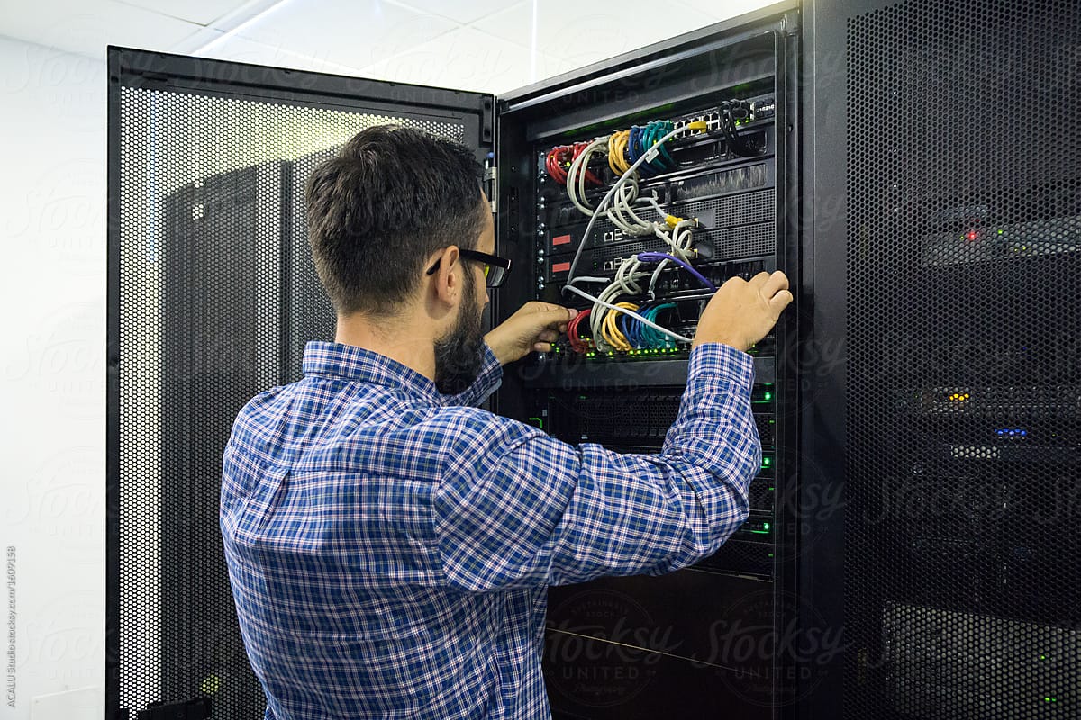 Technician working near a telecom network rack