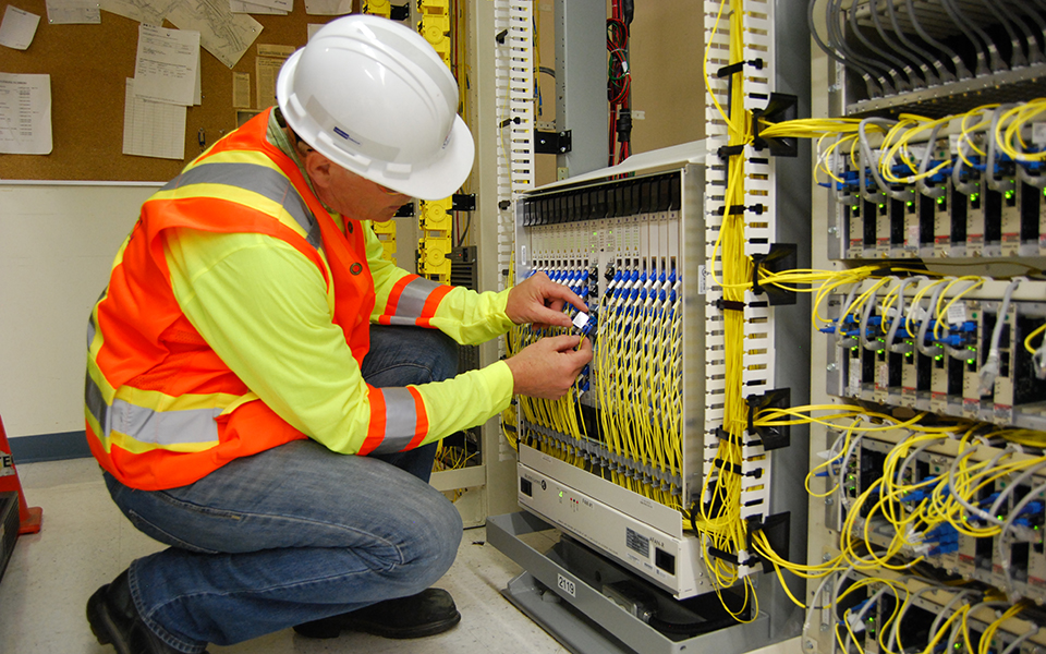 Technician working on fibre and copper connectivity